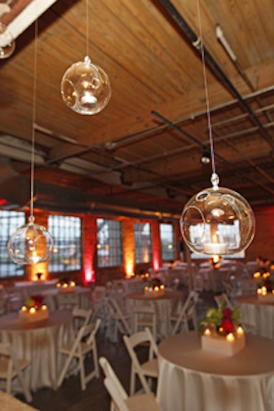 Bubble-like candle holders hung above a low wall that separated the dinner area from the food stations.