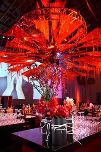 A giant red chandelier was meant to evoke the look of Converse shoes without being too literal, and laces wrapped black flower vases on the bars.