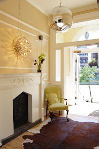 The first-floor entrance to the main dining room features modern lighting fixtures and a faux animal rug.