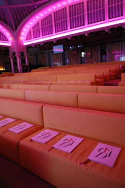 Banquettes upholstered in orange linen lined the hall of Celeste Bartos Forum.