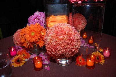 Smaller orange and pink peonies were placed at the base of the larger arrangements, mirroring the spherical design.