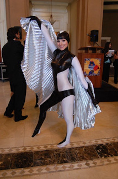 A model—one of eight from Champagne Showgirls—dressed as a superhero named the Silver Raven.