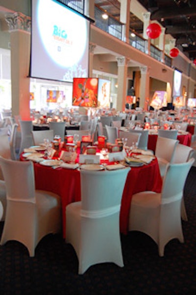 Red linens from Around the Table and cream chair covers from Micki's dressed the dining tables, which featured a box of popcorn at each place setting.