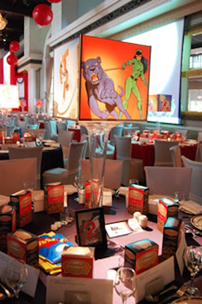 Custom centrepieces featured plexiglass boxes with original images of superheroes.