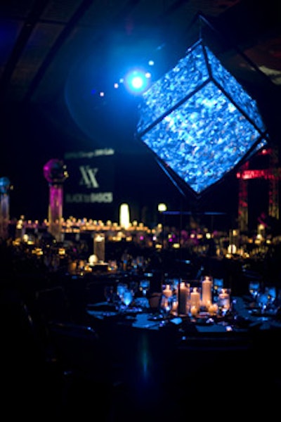 Light-reflecting cubes, disco balls, and votive candles bathed the dining room in dramatic tones.