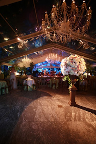 Giant chandeliers adorned the clear-ceilinged tent erected behind the house.