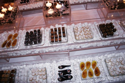 Desserts by Hudson Yards Catering, like miniature raisin crèmes brûlées and peanut butter cheesecakes, sat in troughs of marshmallows.