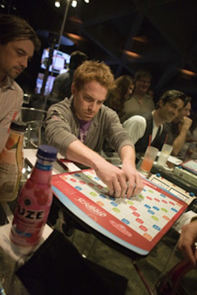 Celebrities and guests played on the diamond-anniversary-edition Scrabble board game.