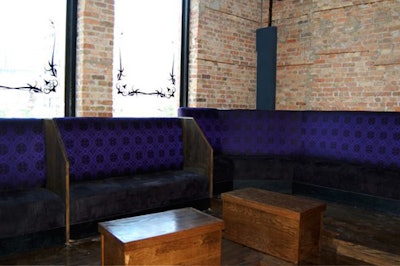 Banquettes along the back wall of the lower level seat about 35.