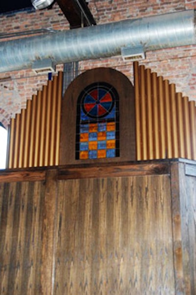 A faux organ hangs on the wall behind the DJ booth.