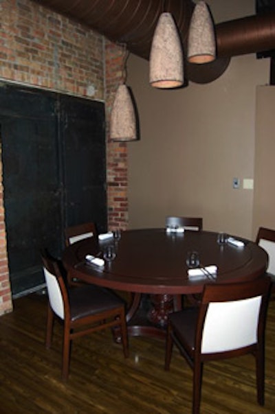 The chef's table sits beside a 100-year-old wrought-iron door that was uncovered during the building's renovation. Crushed-glass lanterns hang overhead.
