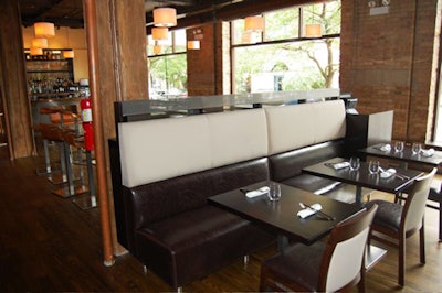 A semiprivate dining room is filled with chocolate leather banquettes.