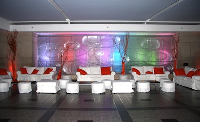 Indoors, on the west side of the rink, tangerine-colored pillows accented white lounge chairs placed before a beveled glass wall.