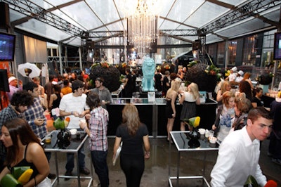 Three chandeliers and two lion statues created a focal point at the central bar in the clear-topped tent.