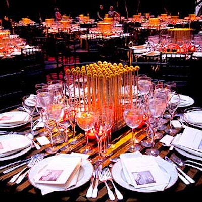 For a gala celebration for two concurrent Mies van der Rohe exhibits, Avi Adler's striking centerpieces consisted of gold poles standing on a black base with yellow Craspedia perched on top. Black and yellow striped silk tablecloths elegantly draped the tables.