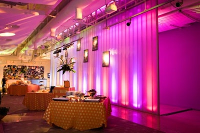 The pink- and purple-lit conference room was home to posters from SilverDocs, a buffet on orange and gold polka-dotted linens, and orchid and calla lily centerpieces in two-foot-tall glass cylinders.