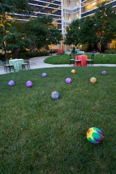 Tie-dyed beach balls littered the outdoor garden, attracting several guests to playfully kick them around.