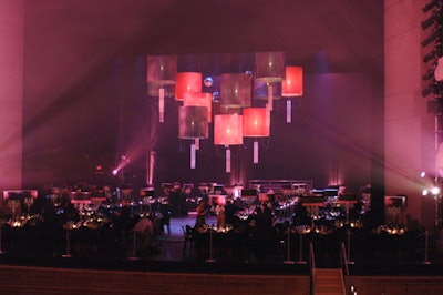 Twelve six-foot custom lit cylinders, in black and pink, suspended over the stage created intimate lighting for the dinner.