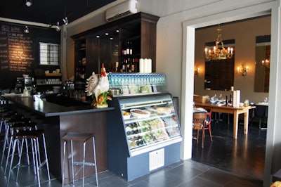 The bar area of the restaurant displays a wine list written on a chalkboard wall.