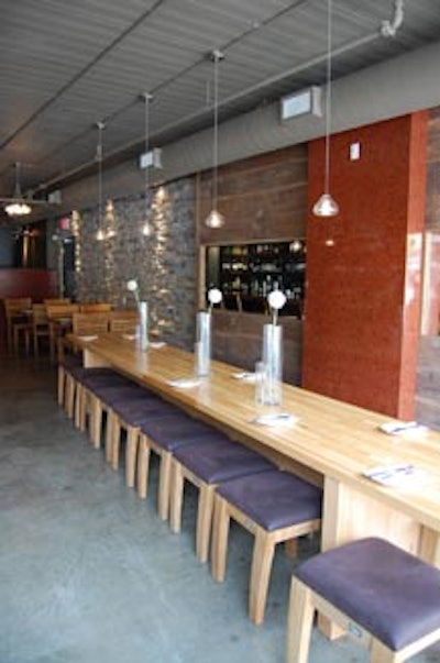 A large community table at the front of the restaurant seats 20.