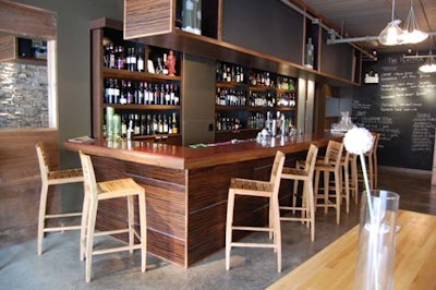 The custom granite and ebony bar features teak seating.
