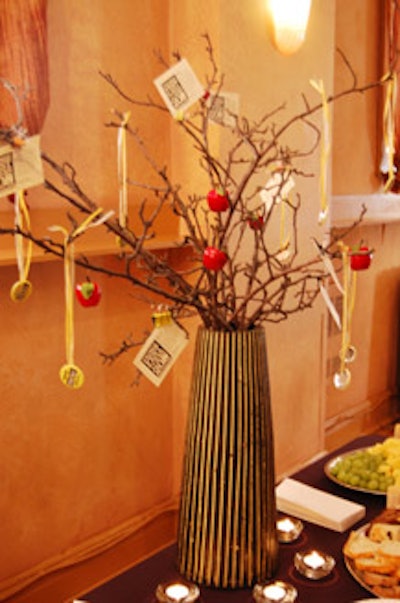 Wooden vases filled with branches decorated the food table.