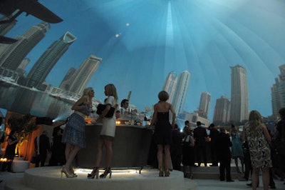 Projectors stationed throughout the room displayed seamless footage of Dubai's coastline while guests sipped cocktails at the bar.