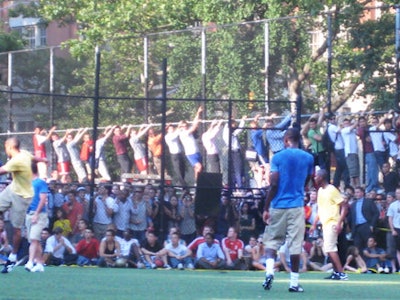 Fans climbed the chain-link fence and trees to get a better view.