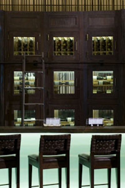 Ten-foot-tall oak cabinets house Eno's extensive wine collection and frame the bar.