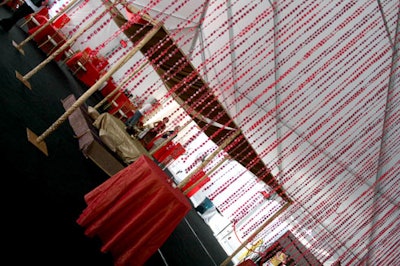 Low tables and plenty of pillows created intimate dining areas at the warehouse's floor level, which was divided from the dance floor by a curtain of red beads.