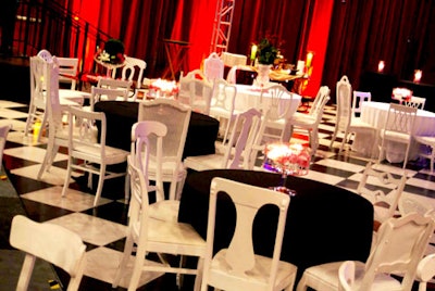 Tables were draped in simple black linens and surrounded by classic white chairs so as not to take attention away from the venue.