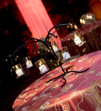 Bednar Designs International Inc. provided rod-iron centerpieces with hanging candles.