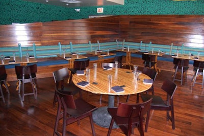 A turquoise banquette wraps around the back wall of the main dining room.