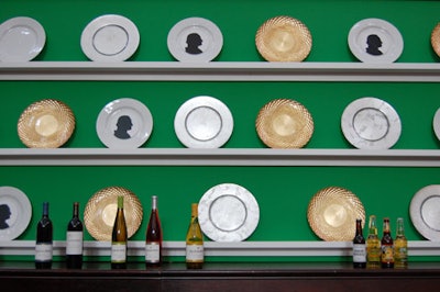 The backdrop of one bar alternated silver, gold, and white plates with silhouettes of George Washington on a tall, bright green shelf.