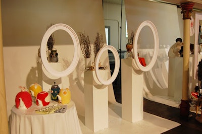 The vignettes, modeled after department-store windows, included hanging picture frames in front of a white paper backdrop.
