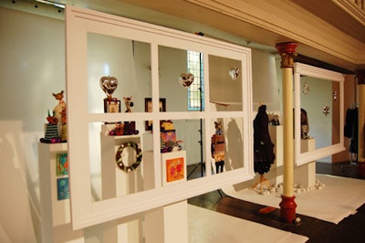 Silver ornaments hung from the window frames of this vignette, which featured children's toys.