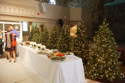 Christmas trees lined the back of the hors d'oeuvres table, and the One of a Kind Show logo was projected onto the back wall of the church.