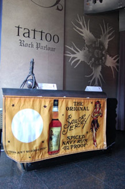 A Sailor Jerry banner dressed the media desk at the entrance to the club.