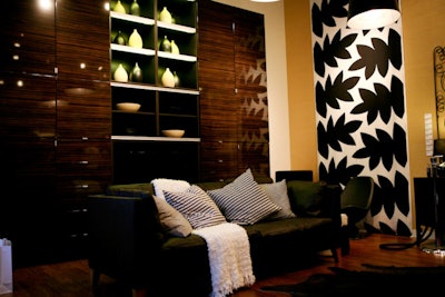 Black-and-white wall hangings and dark modern furniture were set up to convey the look of a high-end design store.