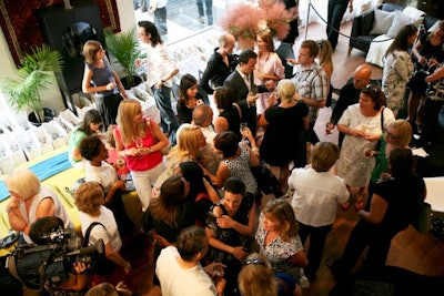 Close to 200 guests, mostly from the media, mingled on the main floor, where floor-to-ceiling windows let in natural light.