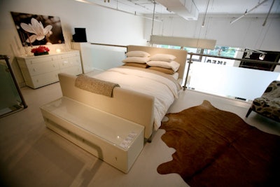 A bedroom set-up on the second floor included glossy white furniture from the new Vinstra collection and a cowhide rug.
