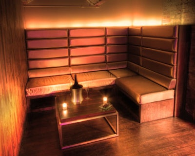 Backlit banquettes and glass-topped tables create intimate nooks in Spybar's new space.