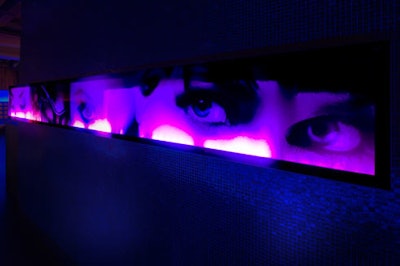 The venue's new decor features an illuminated mural of women's eyes.