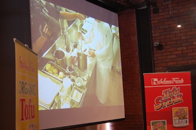 Video footage of the cooking in the kitchen was projected onto a screen in the space where attendees gathered.
