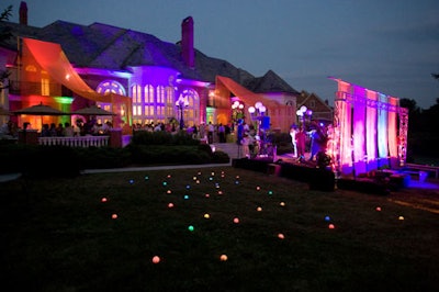 As the band took the stage, the light projections on the house and the tennis ball-sized orbs strewn around the three-acre yard flashed in yellow, red, blue, orange, and purple.