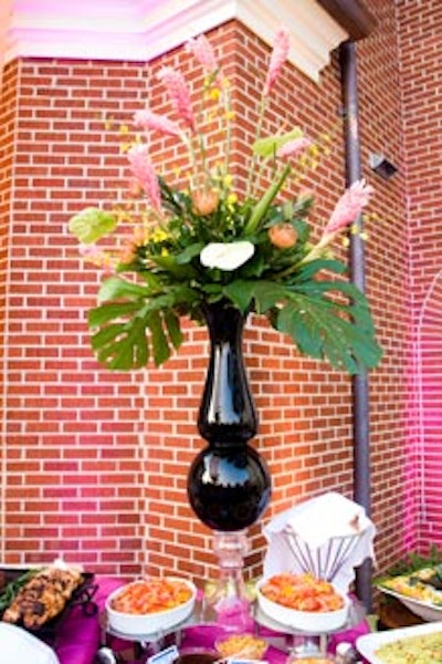 The exotic 4-foot-tall floral arrangements from Exquisite Design followed the tropical theme.