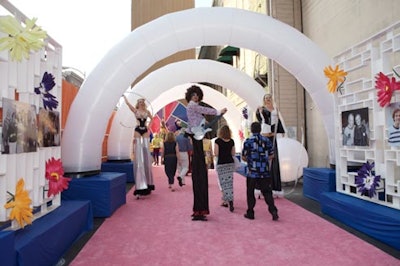 Stilt-walkers greeted guests at an entrance lined with 40 years of photos from the foundation's history.