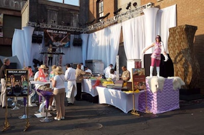 An entertainment stage featured a DJ and a dancer.