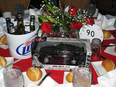 Sponsors decorated the centerpieces with assorted items, such as buckets of beer from Miller and model cars from Ford.