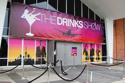 The logo for the Drinks Show decorated banners at the entrance to the Queen Elizabeth Building at Exhibition Place.